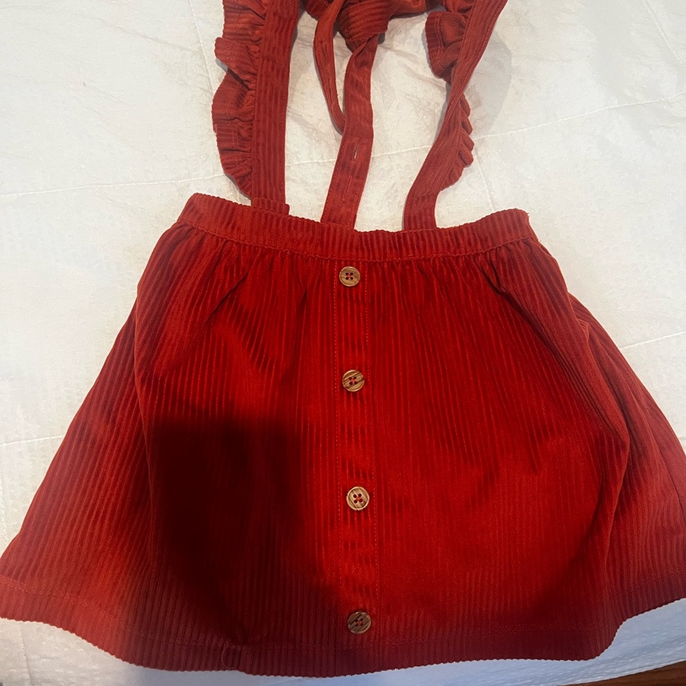 Girls corduroy skirt with shoulder straps.